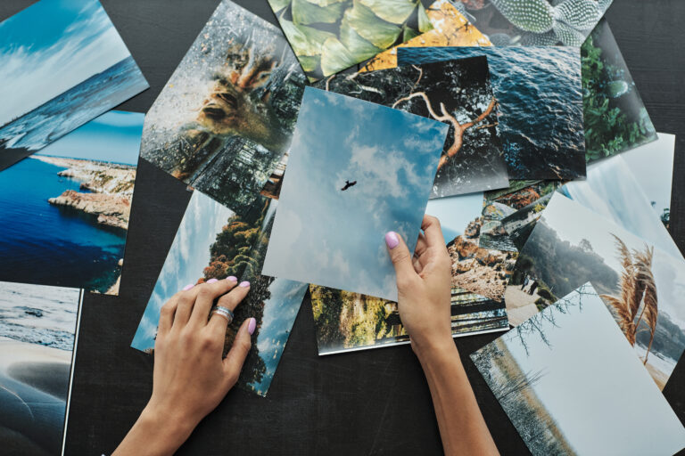 Magazine editor choosing photos for new issue, view from above
